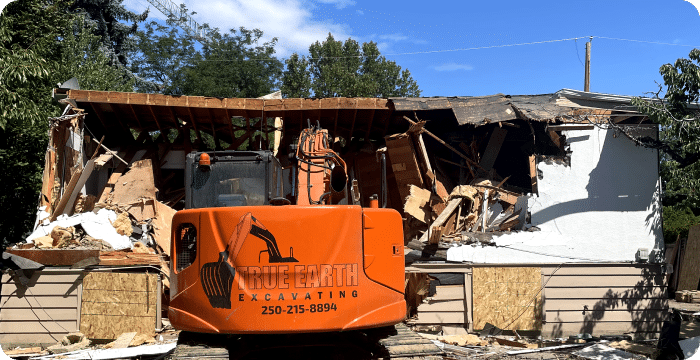 A selective demolition process showing an excavator dismantling a house