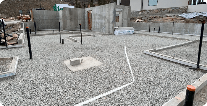 A concrete foundation is being constructed in a yard designated as the surface preparation area